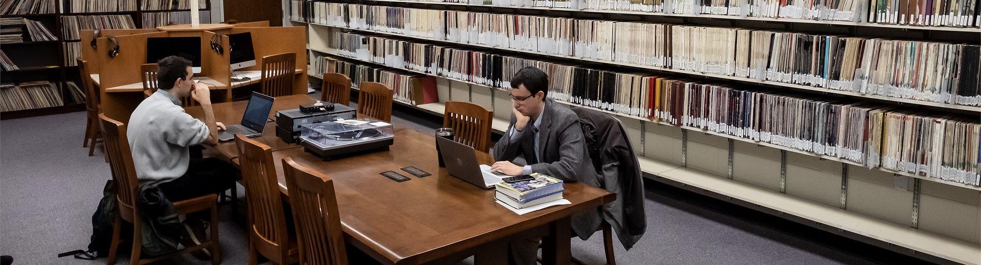 Students working at a long table in the music library.